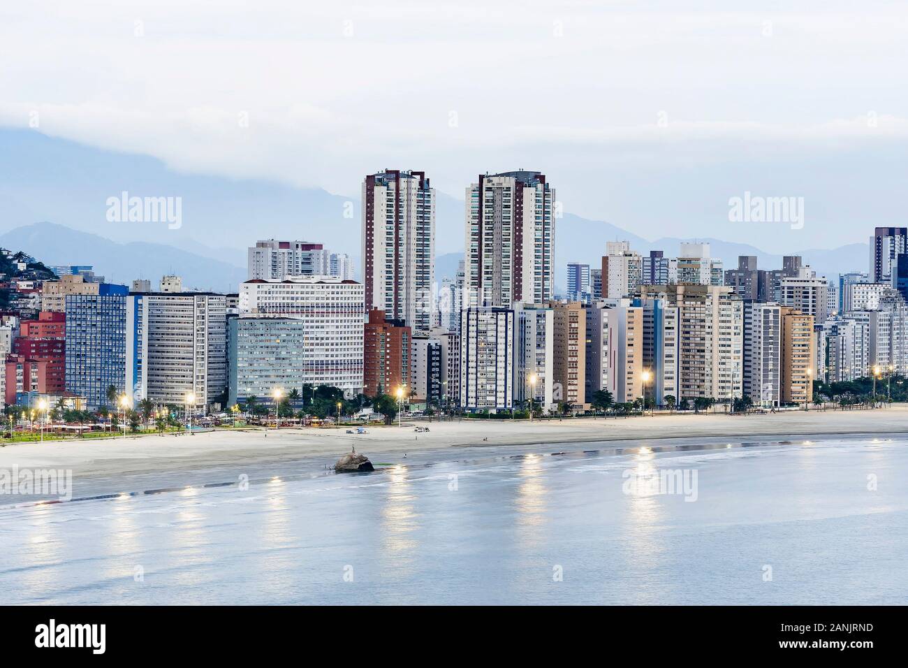 Coastal city at dusk, when the lights of the city begin to turn on. Paulista coast, border between Sao Vicente city and Santos city, SP Brazil. Stock Photo