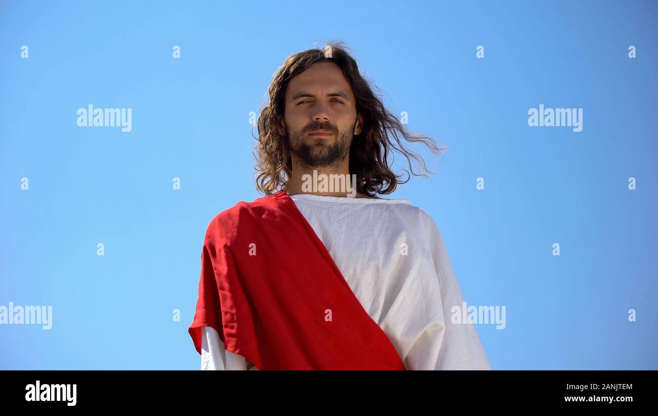 Cheerful god Jesus smiling into camera from heaven, concept to enjoy life Stock Photo