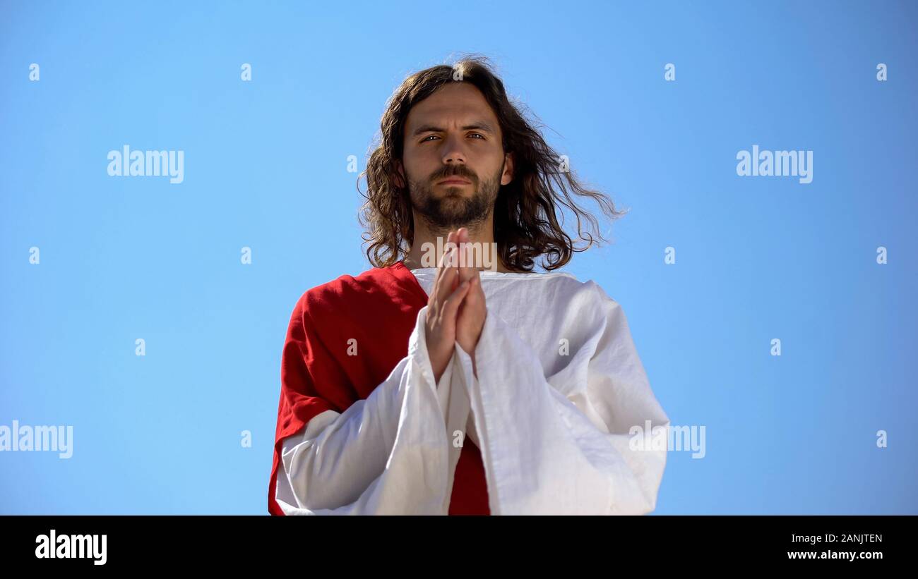 Monk Praying To God Against Sky Background, Asking For Blessing And 