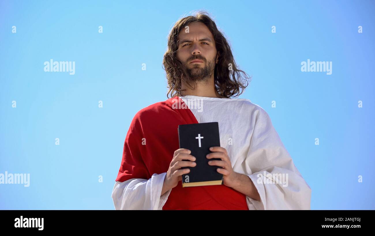 Saint Man Holding Bible Against Sky Faith And Religion Concept