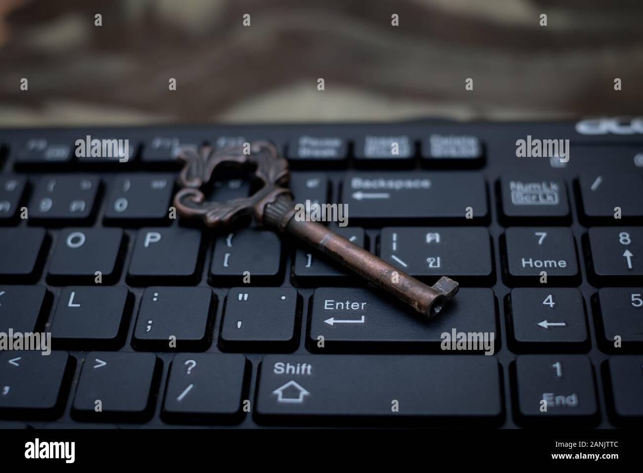 Close up old key and push-button the computer keyboard, Data protection by key concept Stock Photo