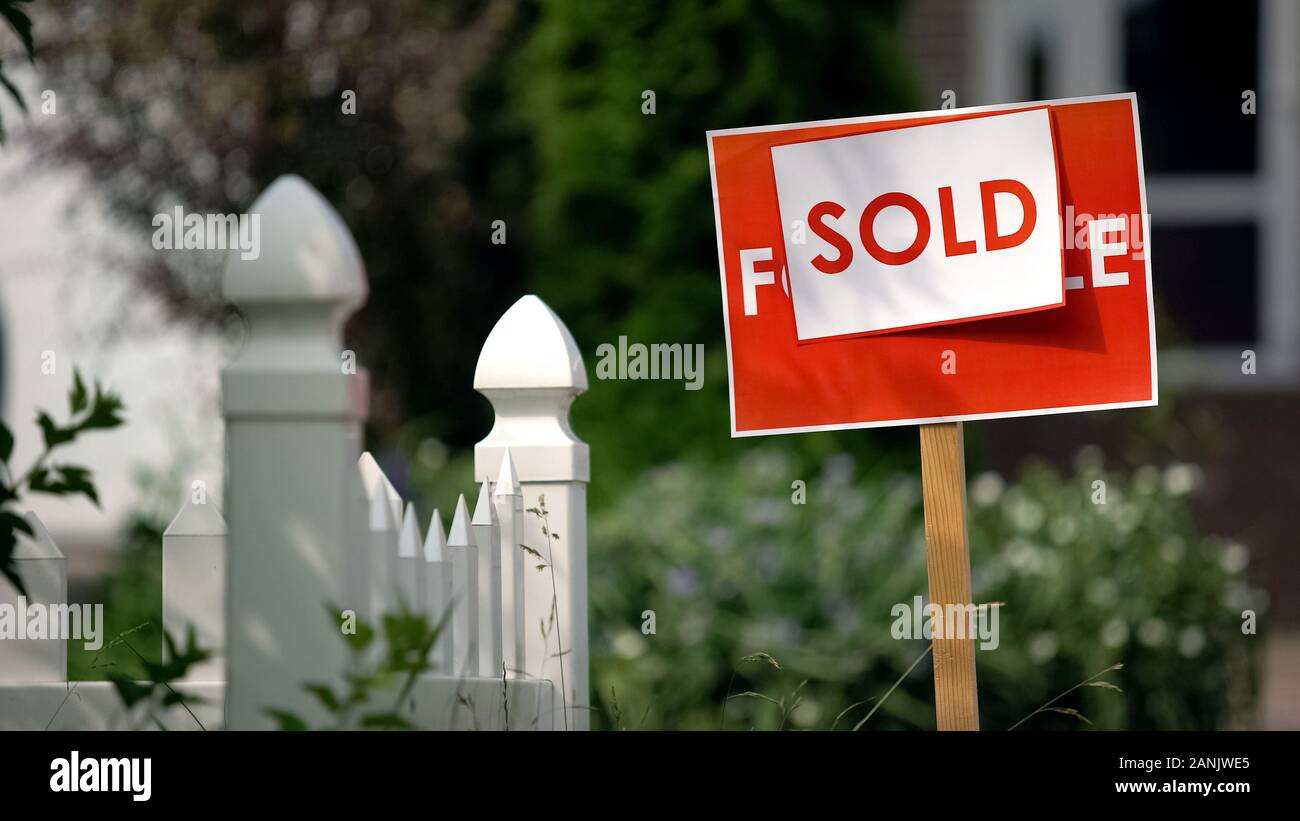 Signboard With Inscription Sold inscription on for sale signboard installing in garden in front of ...