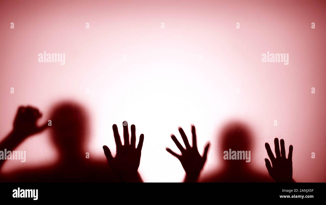 Silhouettes behind glass trying to escape from room, red flashing