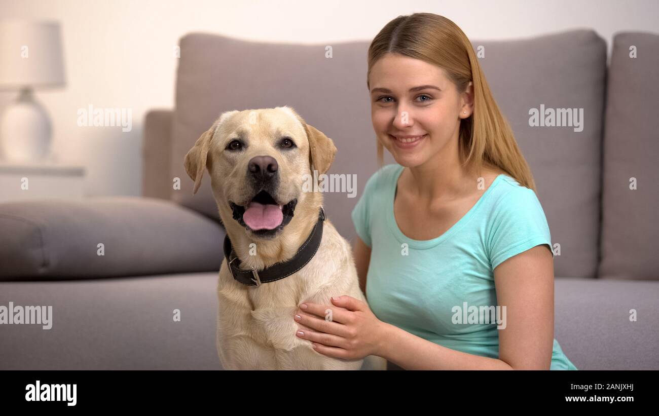 Cheerful labrador retriever dog female owner smiling to camera pet companionship Stock Photo