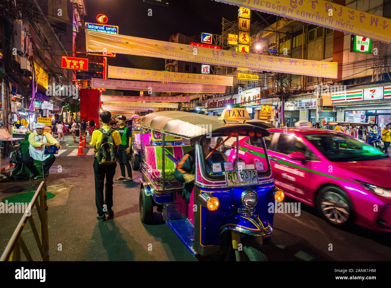Bangkok/Thailand-05December2019: Night celebration of The King's Birthday event on Yaowarat road with banners over the street and people yellow shirts Stock Photo