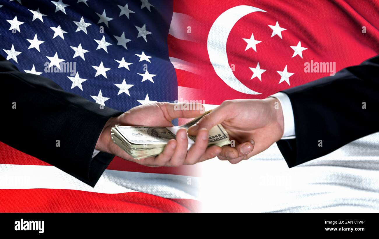USA and Singapore officials exchanging money, flag background, partnership Stock Photo