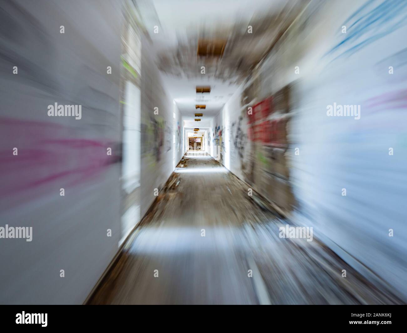 Running through corridor abandoned house colored patches patchy walls Stock Photo