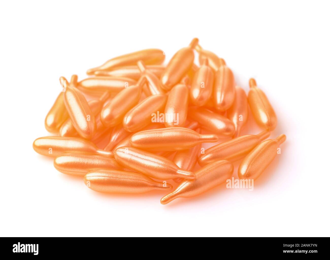 Pile of plastic orange capsules isolated on white Stock Photo