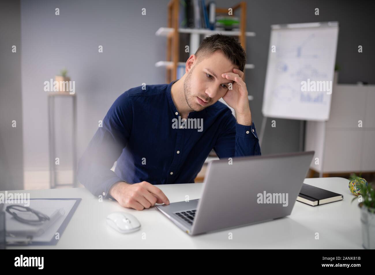 Stressful Business Man Working On Laptop In Office Stock Photo