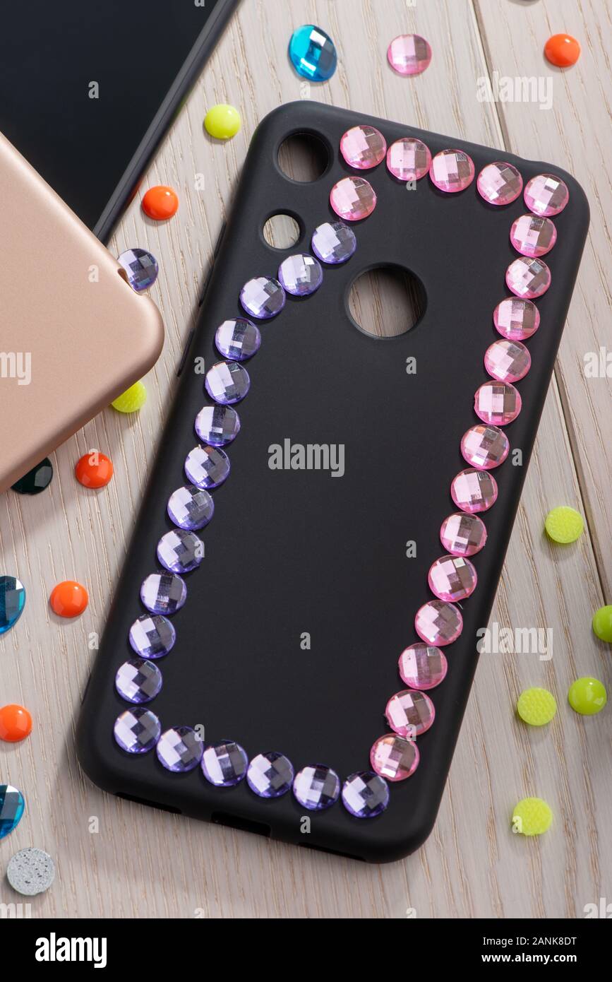 Black phone case decorated with pink rhinestone frame Stock Photo Alamy