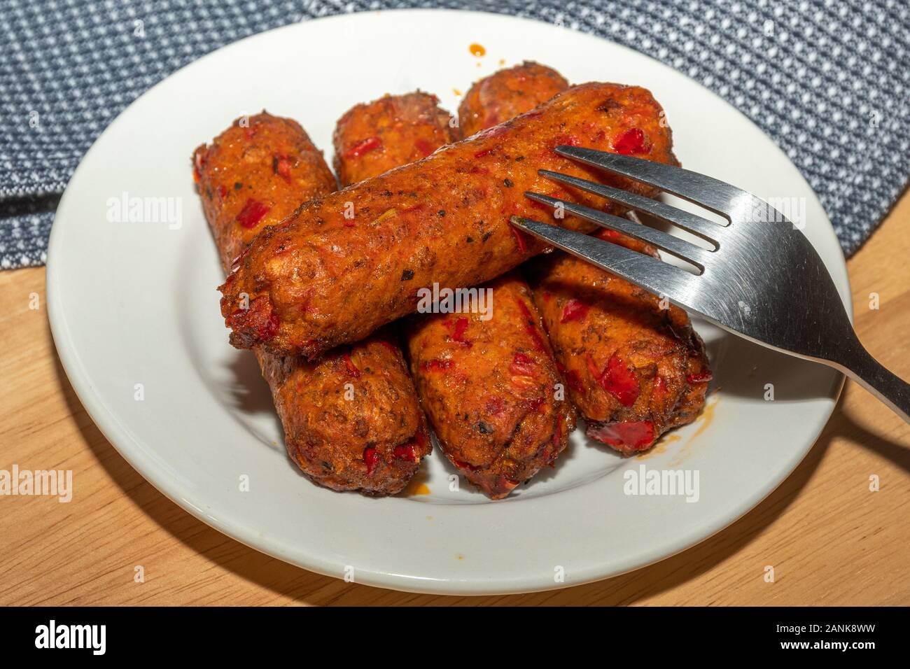 Vegetarian food - Linda McCartney's vegetarian chorizo and red pepper sausages on a plate Stock Photo