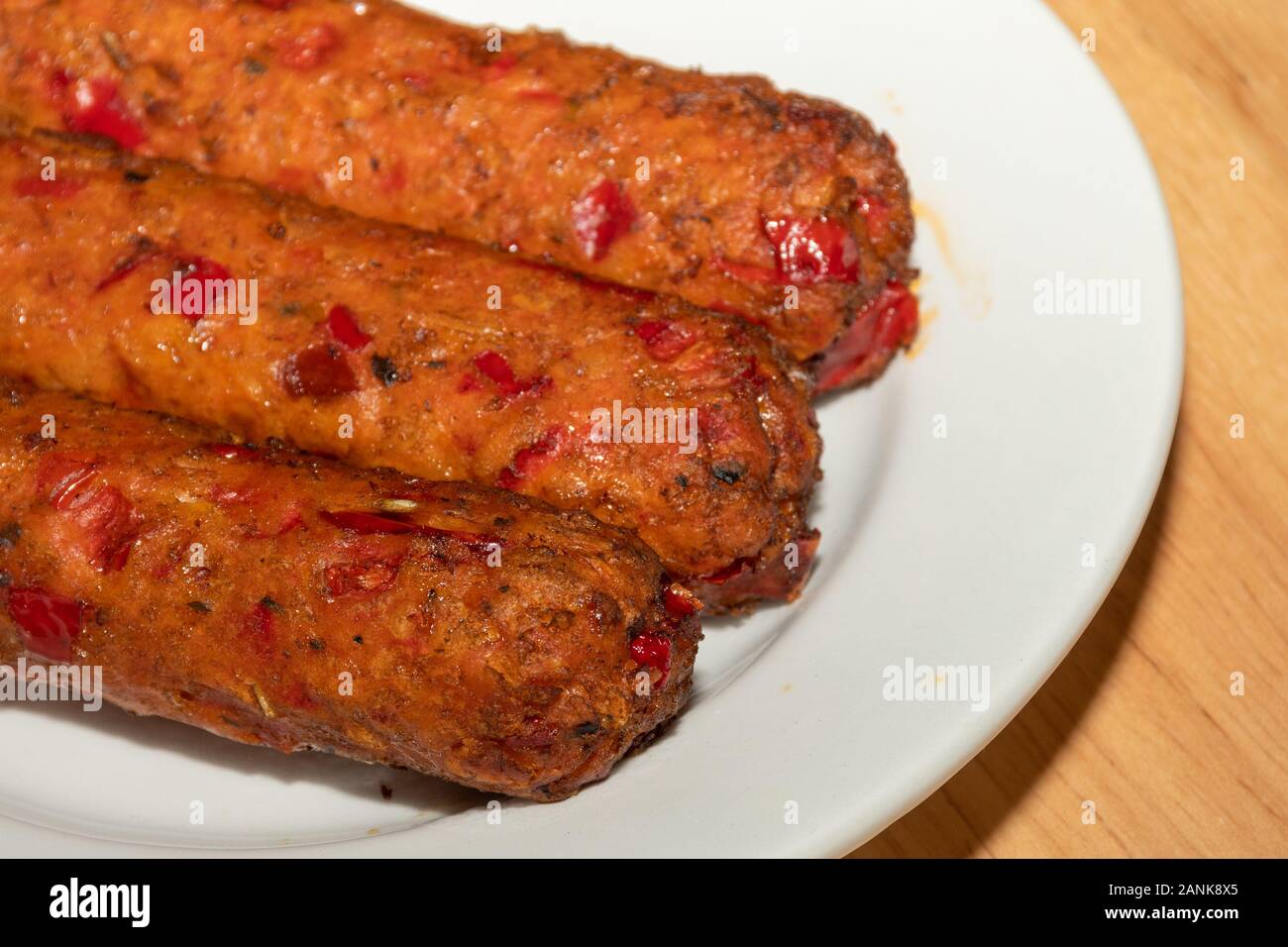 Vegetarian food - Linda McCartney's vegetarian chorizo and red pepper sausages on a plate Stock Photo