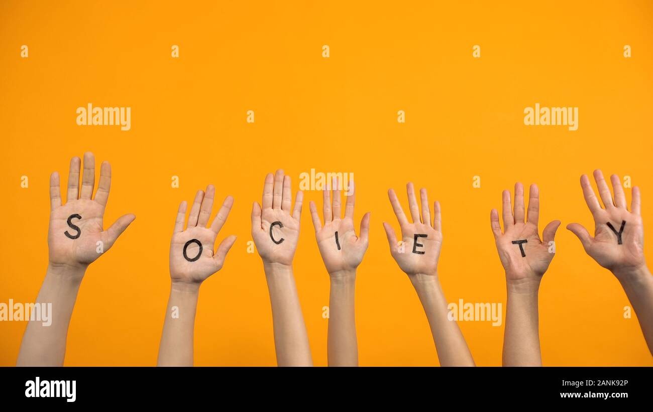Society written palms on orange background, teamwork togetherness, support Stock Photo