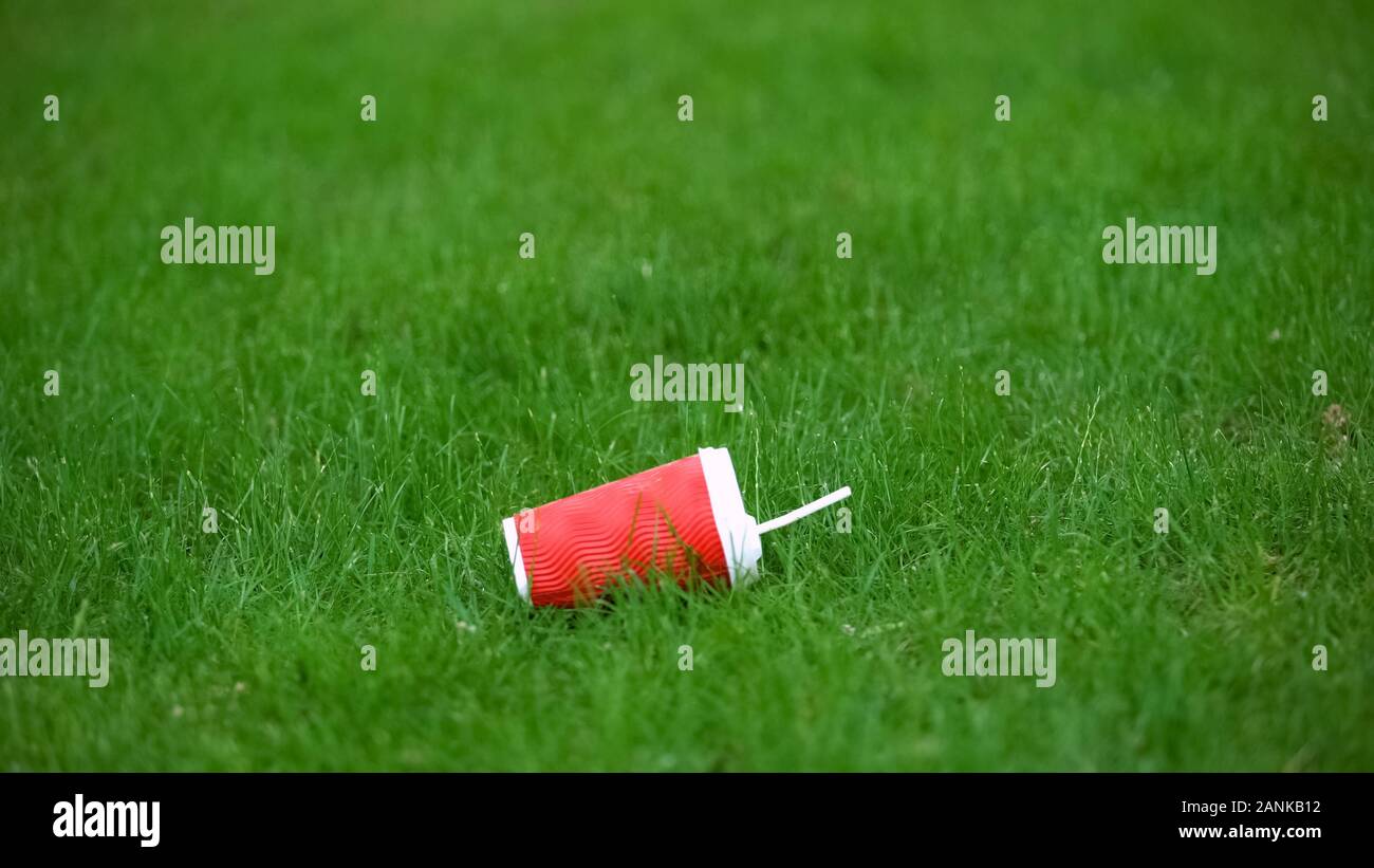 Empty paper cup lying on grass, food waste recycling, environmental ...