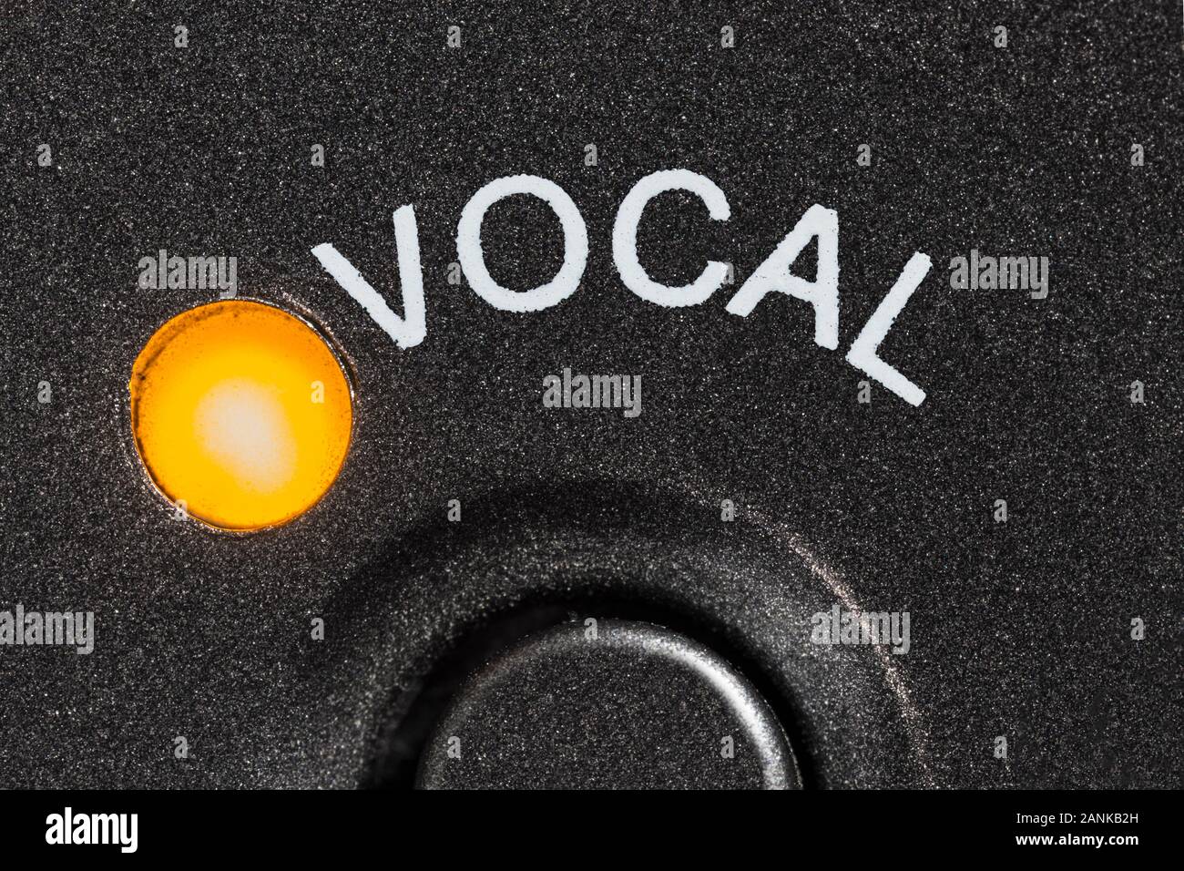 Macro close up photograph of vintage tape machine vocal microphone button and indicator light. Stock Photo