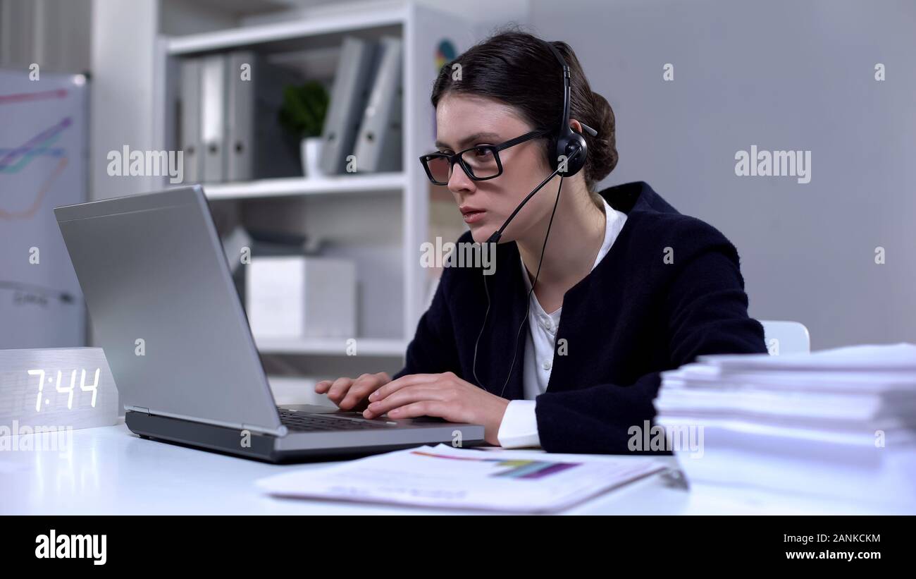 Help Desk Worker In Headset Calling Client Using Laptop Online