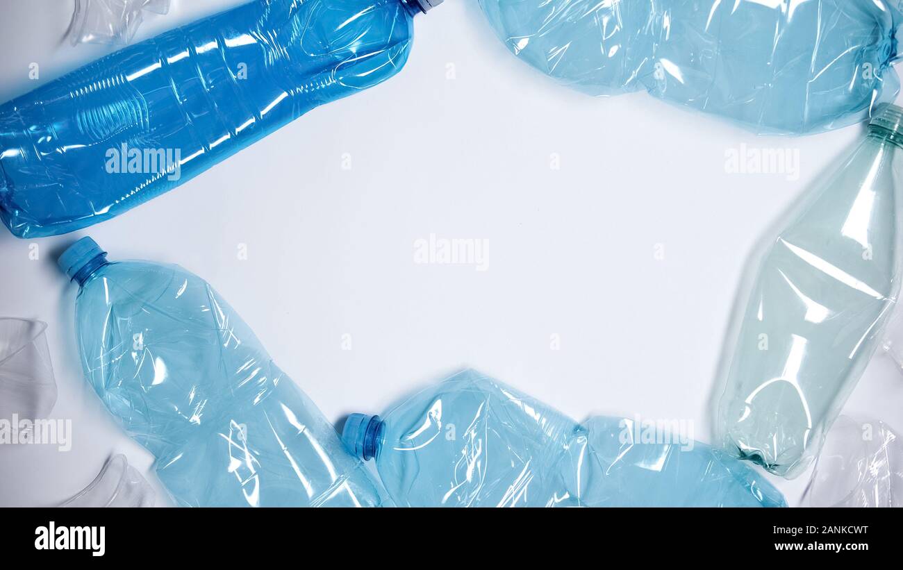 Empty plastic bottles lying on white background, utilization concept, ecology Stock Photo