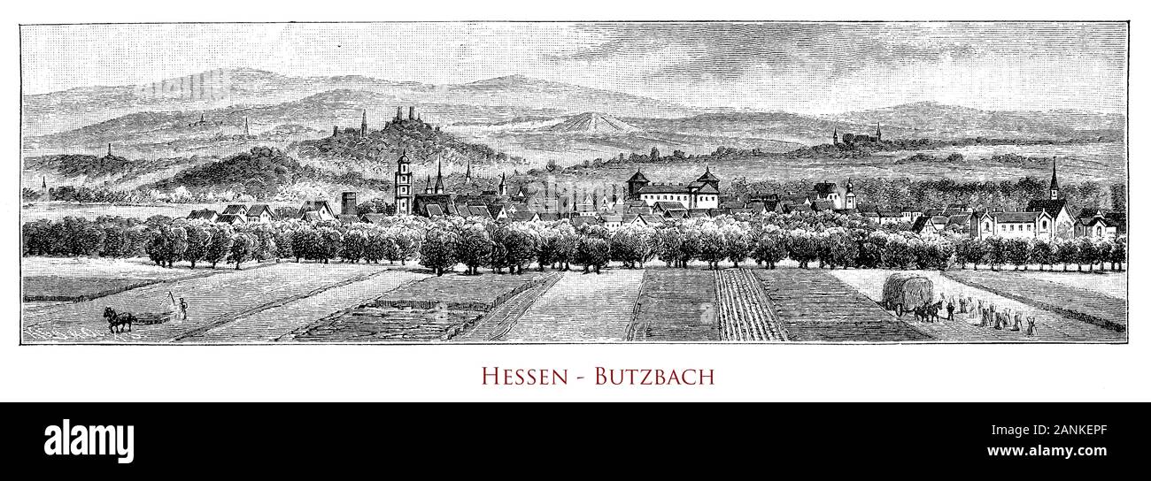 Germany, Hessen - Panoramic view of  Butzbach and its valley. The Panoramic view of Butzbach valley, Germany. Heidelbeerberg overlooks the town, another much higher mountain nearby is the Hausberg with a look-out tower. In the town are remarkable old frame houses of the 16th century and the landgraves’ castle with the romantic park Stock Photo