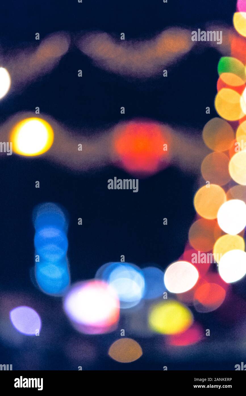 christmas lights on the streets at night. abstract blurred background toned in blue Stock Photo