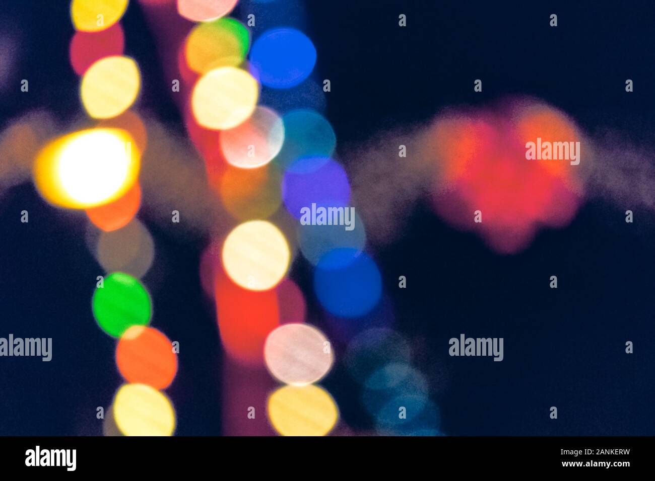 christmas lights on the streets at night. abstract blurred background toned in blue Stock Photo