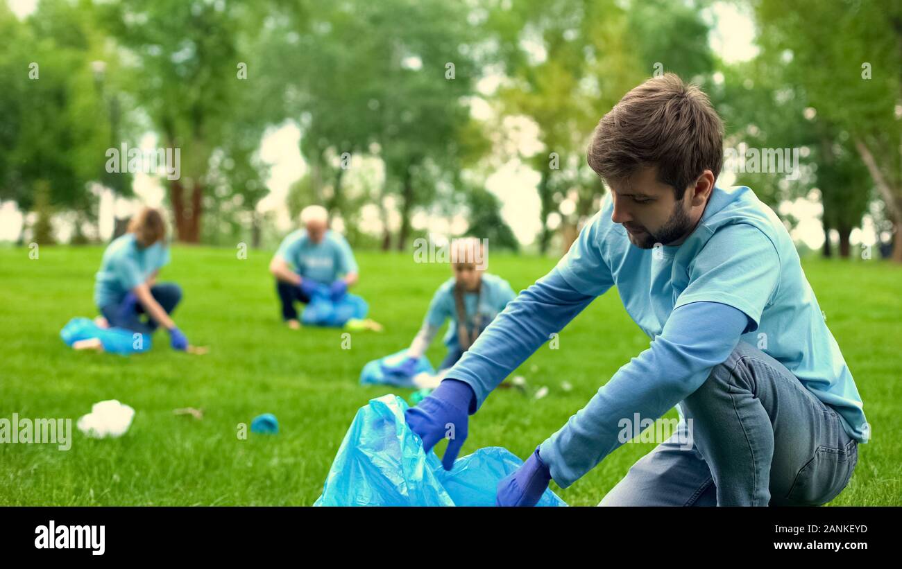 Female picking up litter park hi-res stock photography and images - Alamy