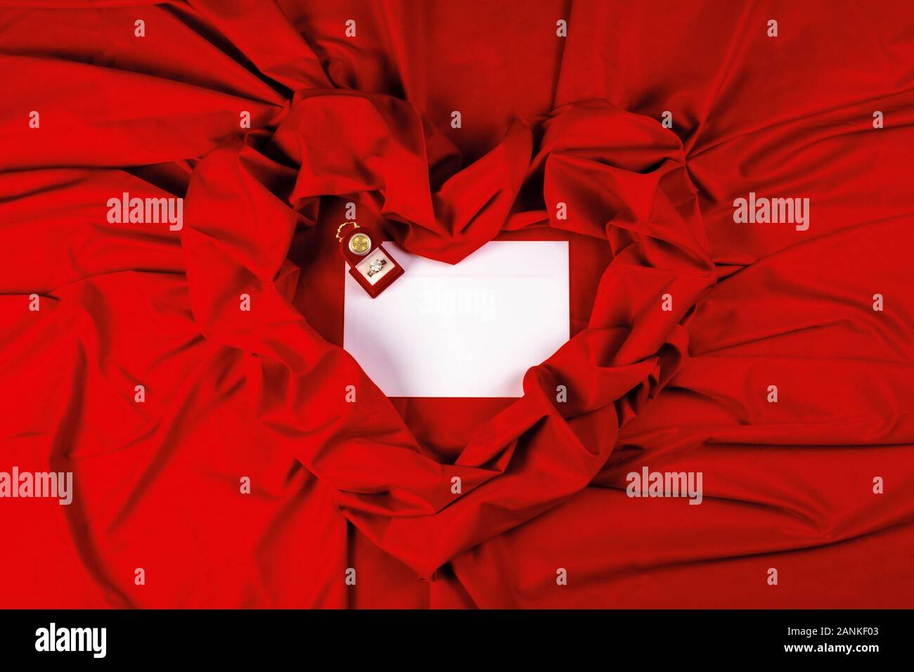 valentine card composition on a red fabric. there is always some madness in love let me be yours message. Stock Photo
