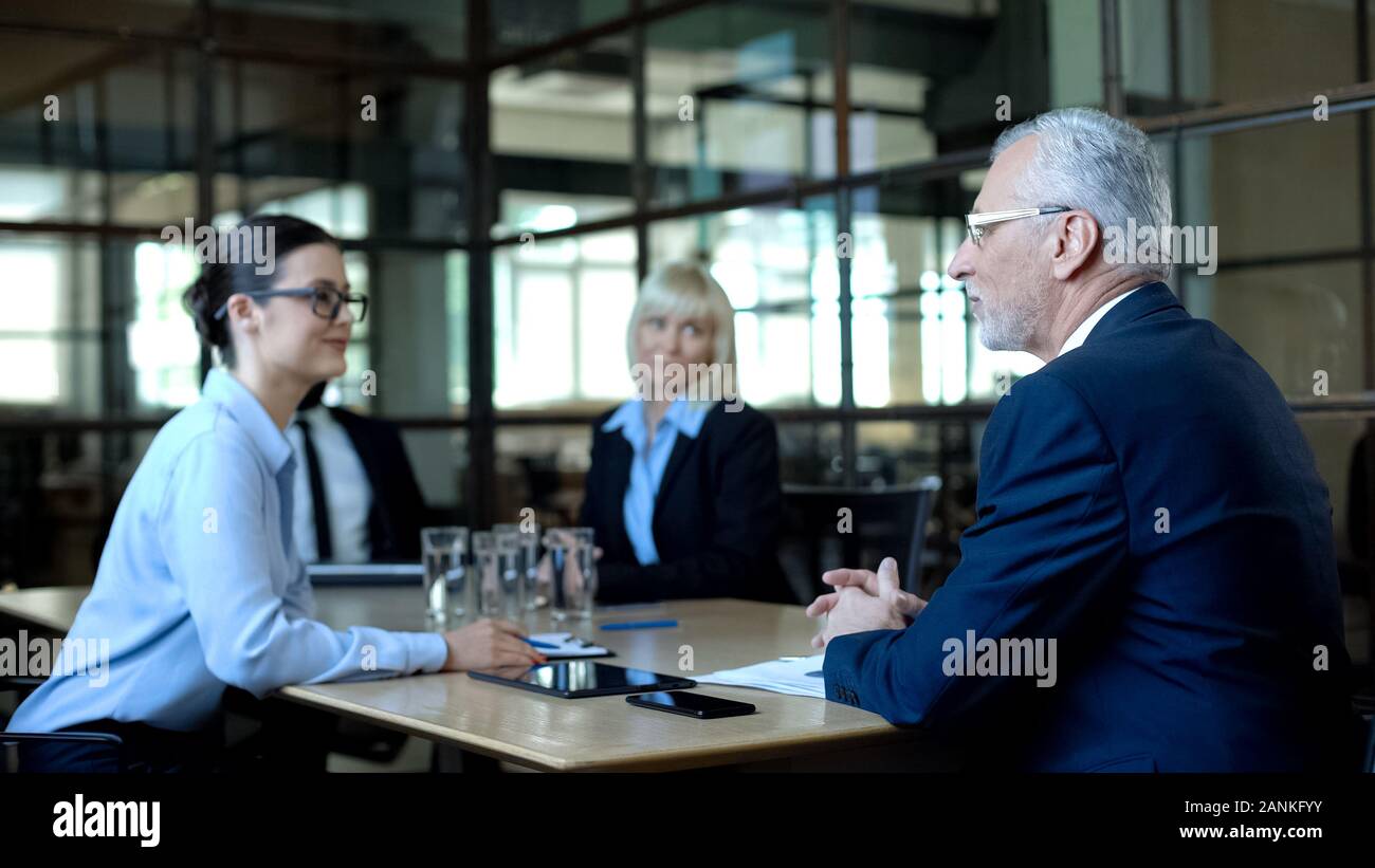 Male company director holding team meeting in office, discussing sales results Stock Photo