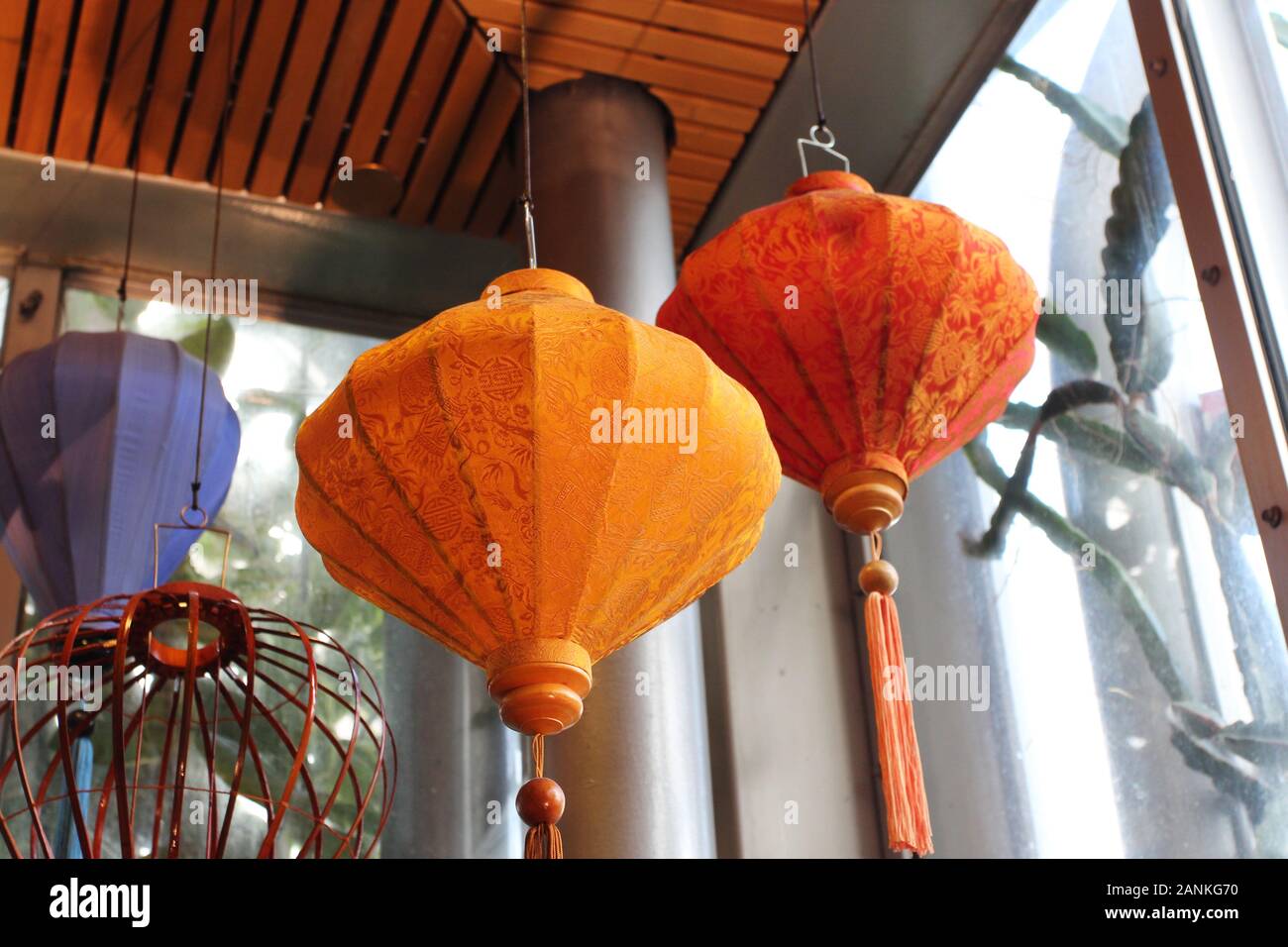 Orange and blue Japanese lanterns hanging from the ceiling Stock Photo -  Alamy