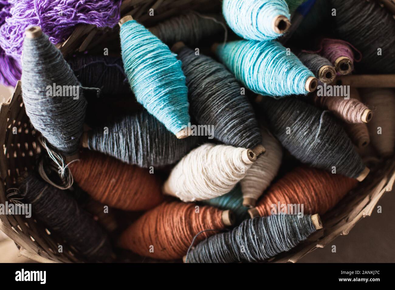 Vintage filling carriers of the loom with spool of colorful threads inside Stock Photo