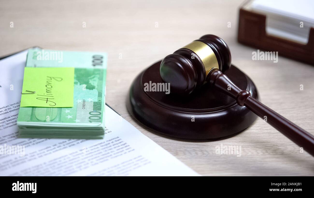 Euro with alimony sign table, gavel lying sound block, financial obligation Stock Photo