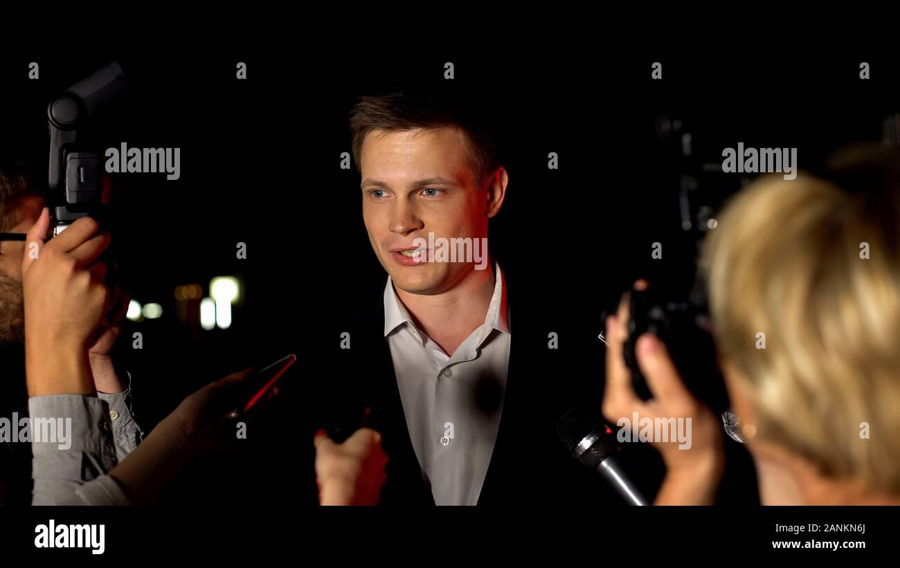Handsome actor giving interview on press conference before movie ...
