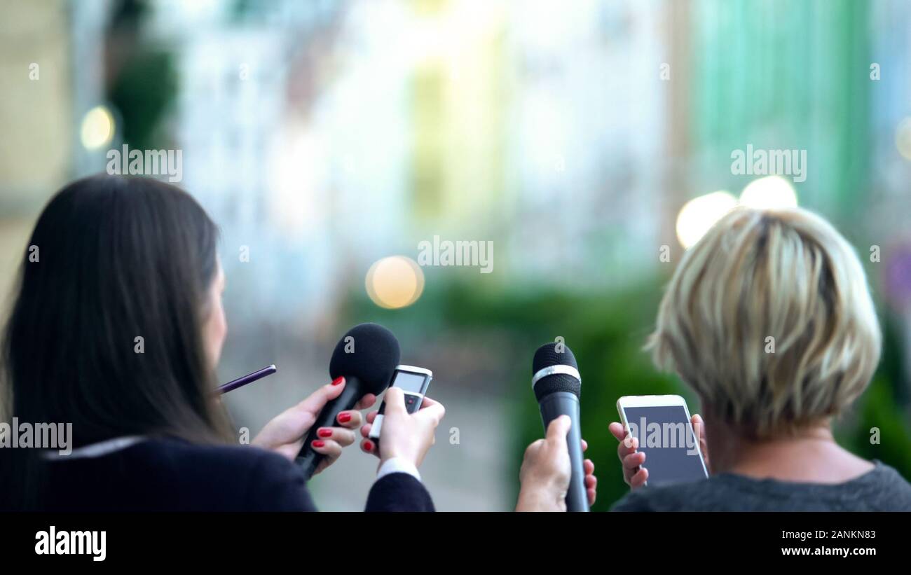 Journalists waiting superstar for interview, holding microphones and dictaphones Stock Photo
