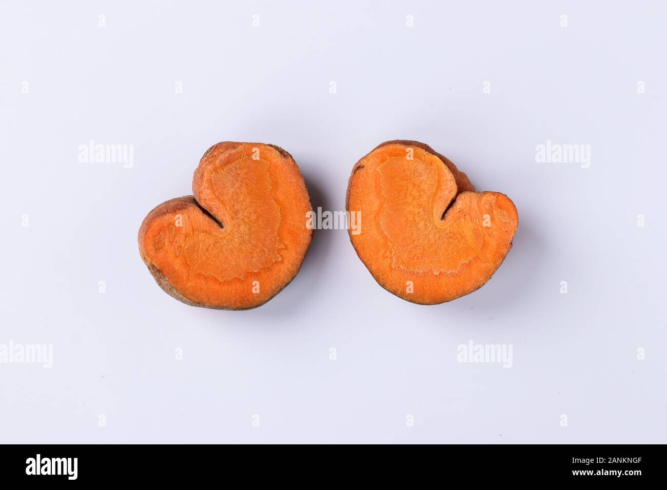 Slices of organic carrots in the shape of hearts, concept for Valentine's Day, love-carrots, Closeup Stock Photo
