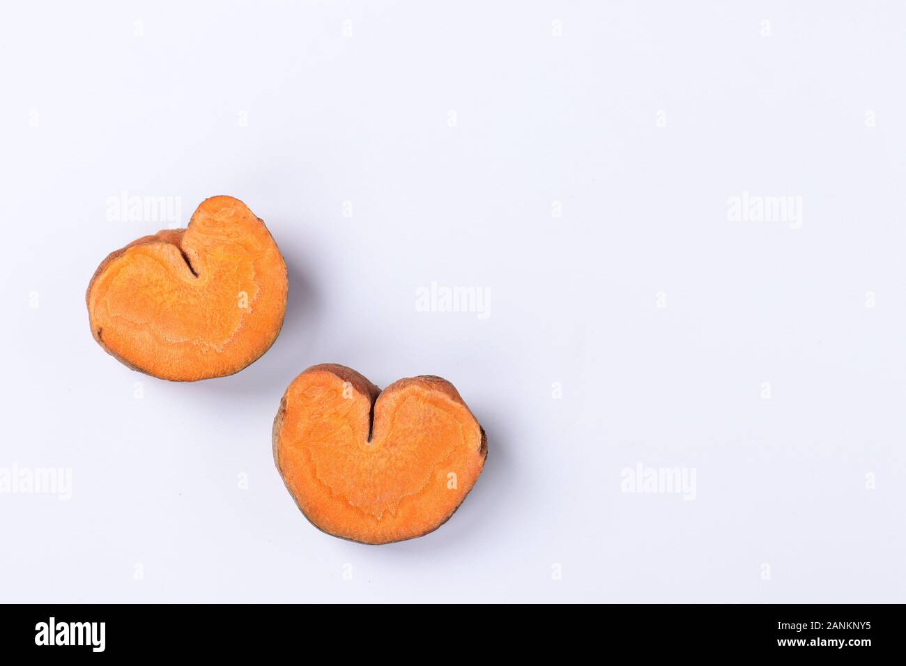 Slices of organic carrots in the shape of hearts, concept for Valentine's Day, love-carrots, Closeup, Top view Stock Photo