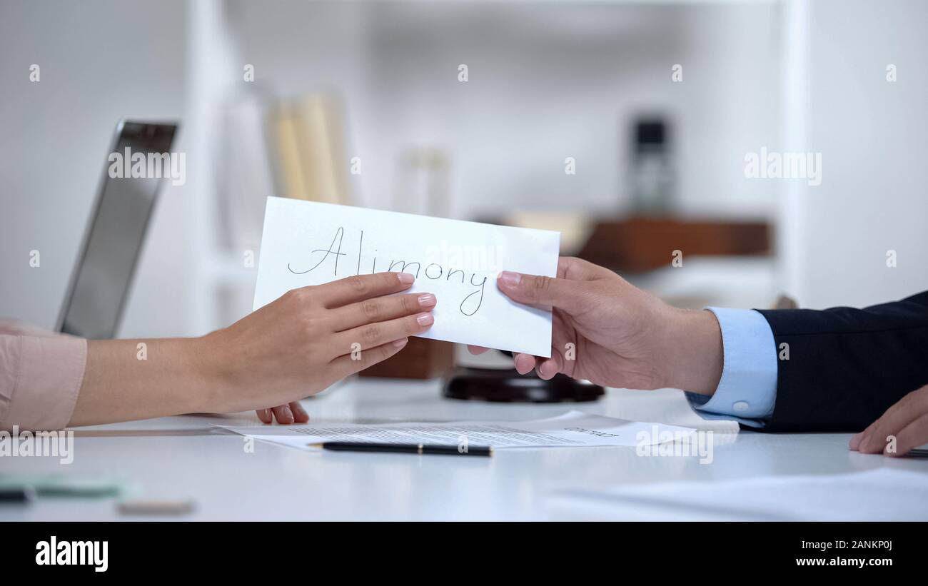 Attorney giving alimony to divorced woman, savings for single mother, legacy Stock Photo