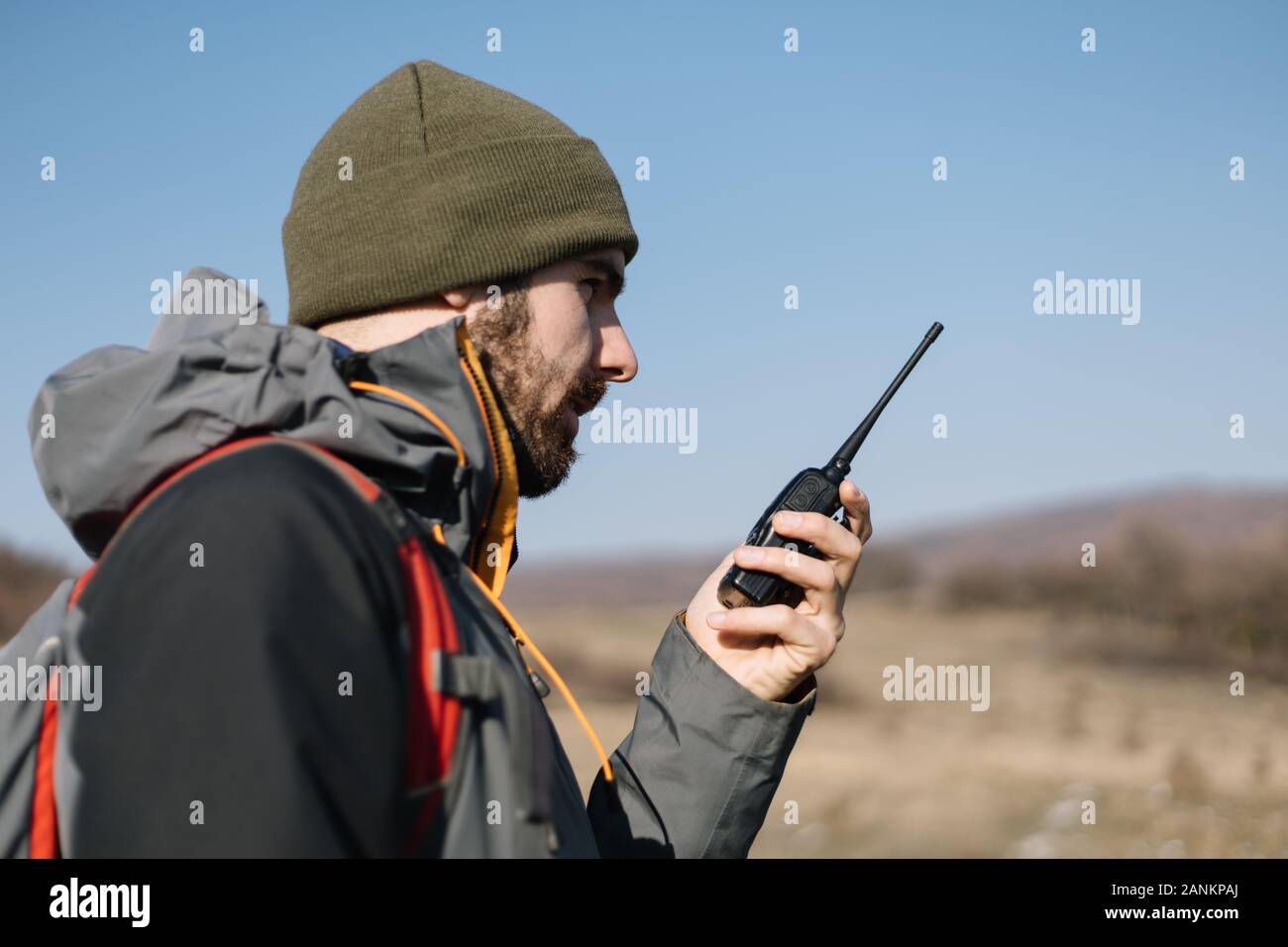 Tourist man speaking on mountain walkie talkie Stock Photo - Alamy