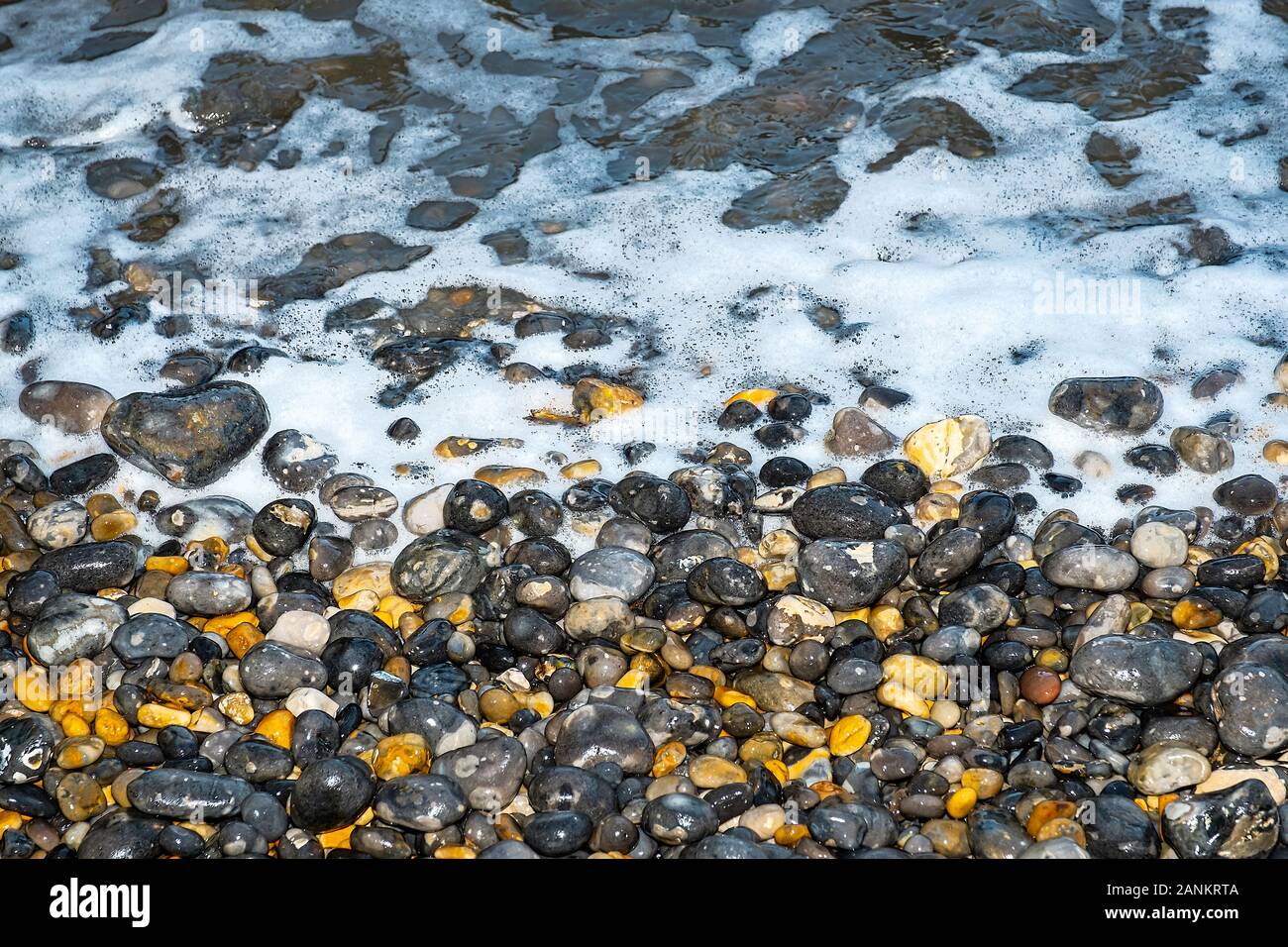 Swirling seas on a North Norfolk Pebble Beach, UK Stock Photo - Alamy