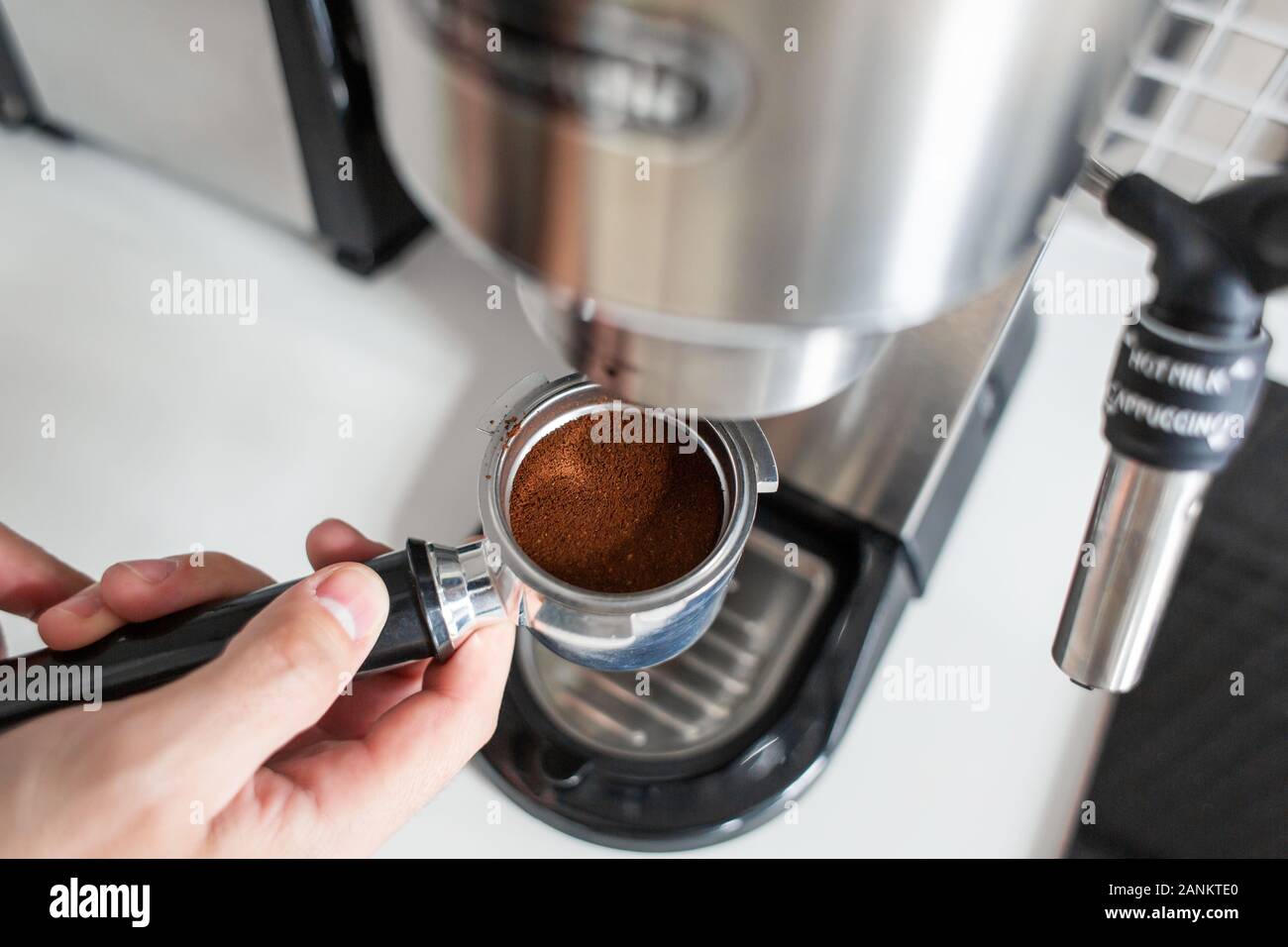 Guy prepare delicious aromatic coffee in a coffee machine. A simple way