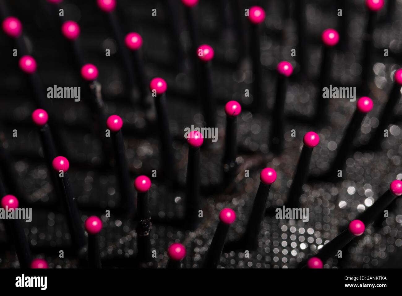 Macro image of a well used hairbrush with some damaged bristles and a