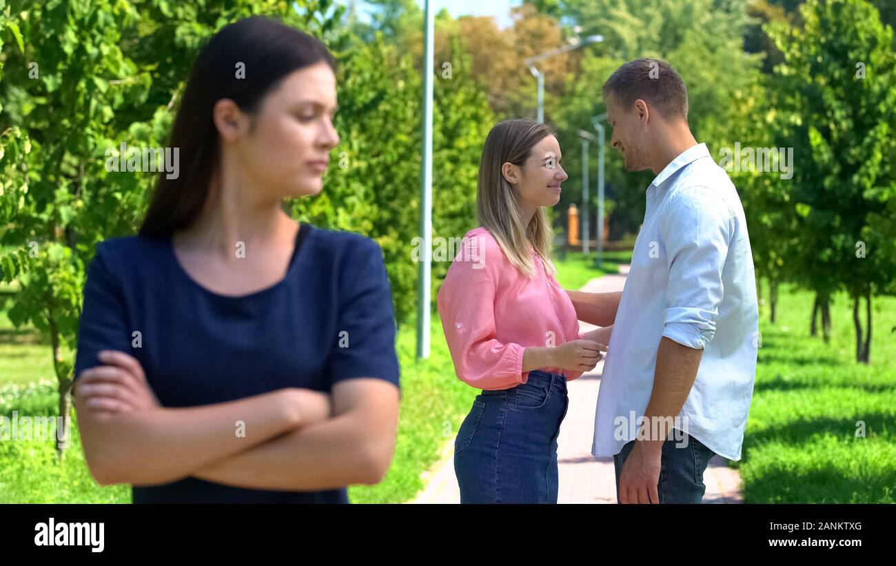 To be envious of. Envious. jealous-candidate +18. girl stands between 2 guys.