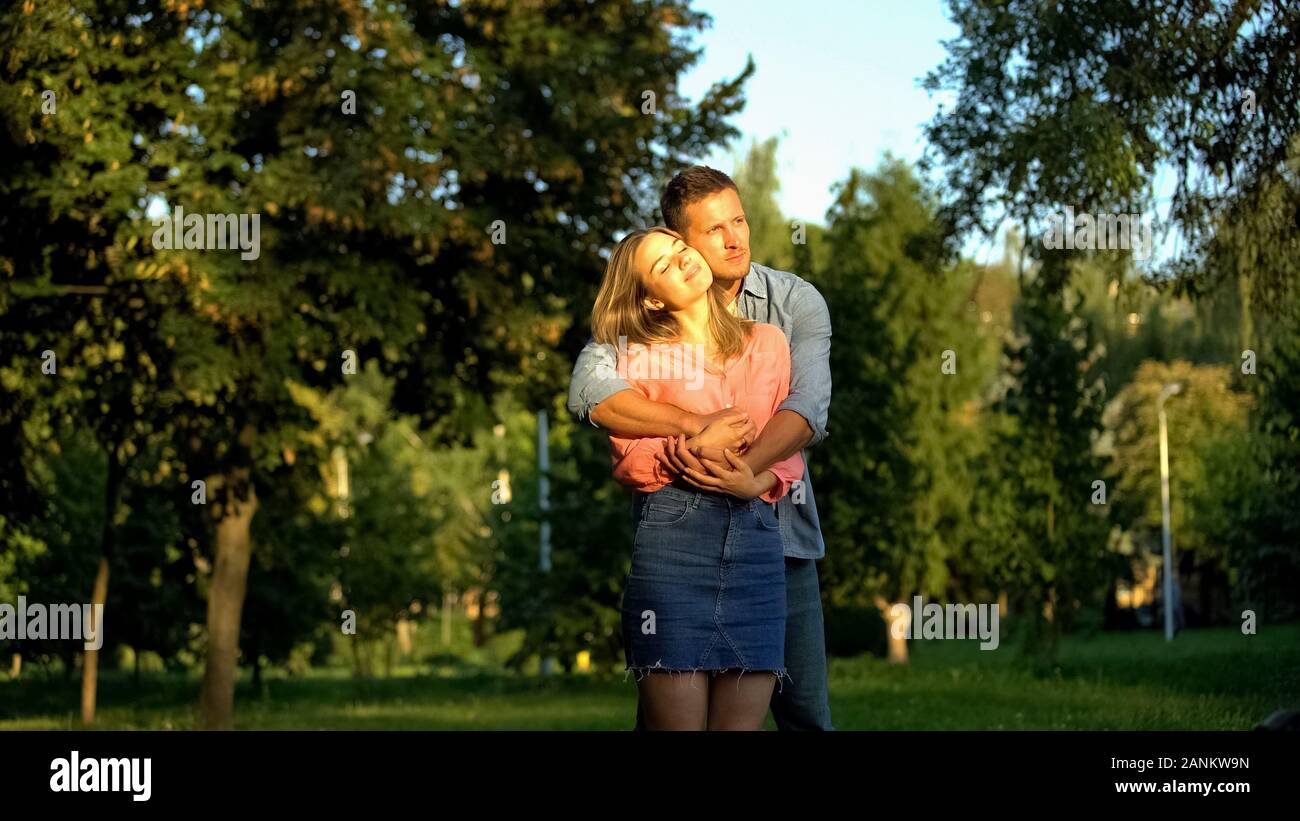 Boyfriend hugging girlfriend spending time together outdoors, love ...