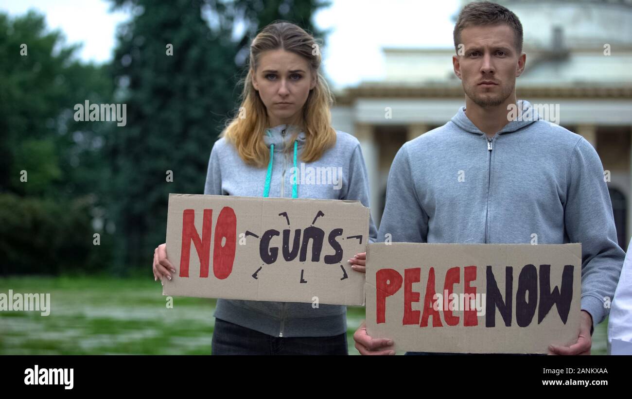 Young people showing slogans for world peace, against nuclear weapon, terrorism Stock Photo