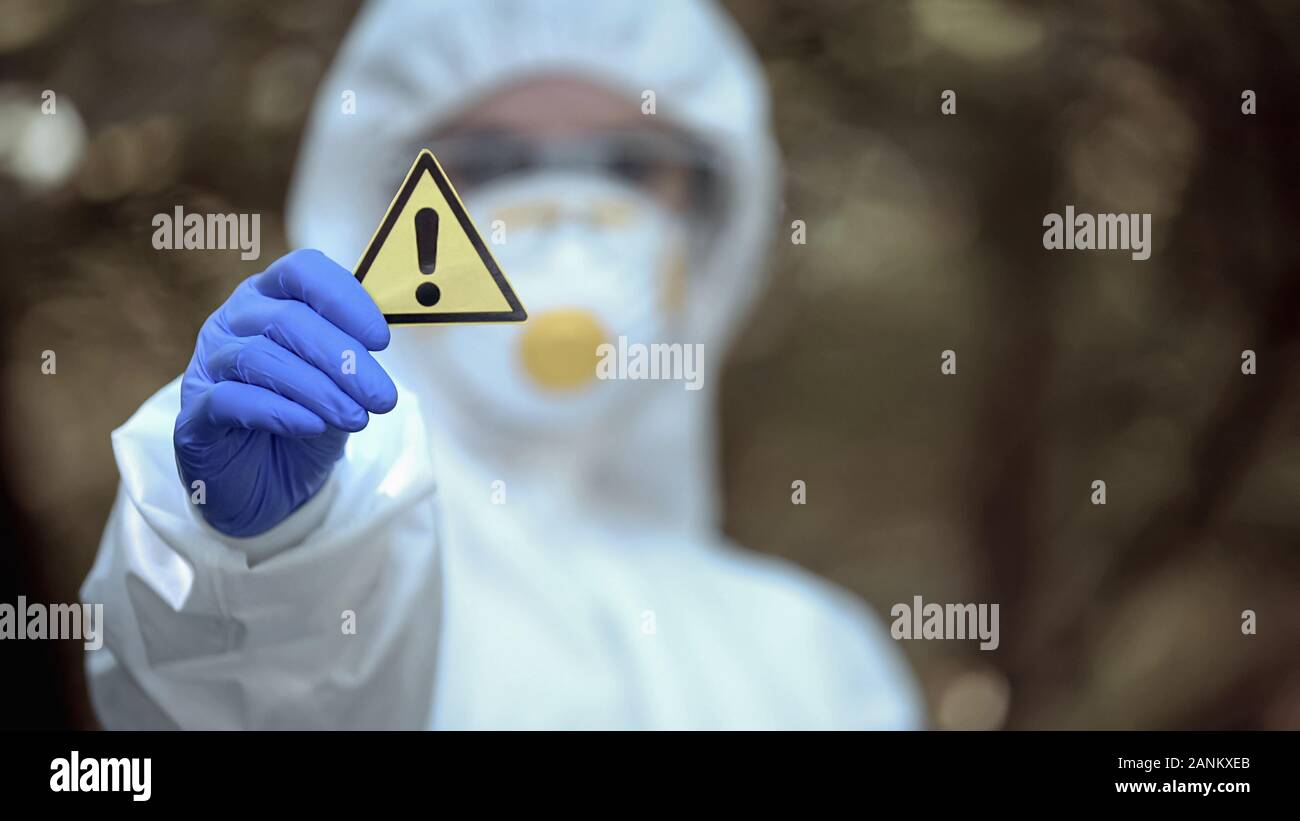 Biochemistry scientist showing generic caution sign in hand, warning disaster Stock Photo