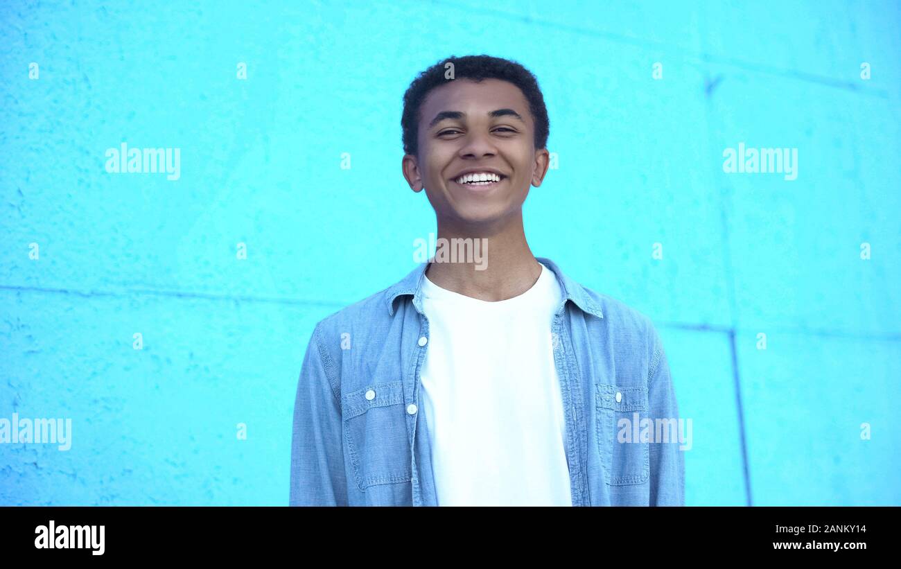 Cheerful african american teenager smiling before camera, satisfied with life Stock Photo