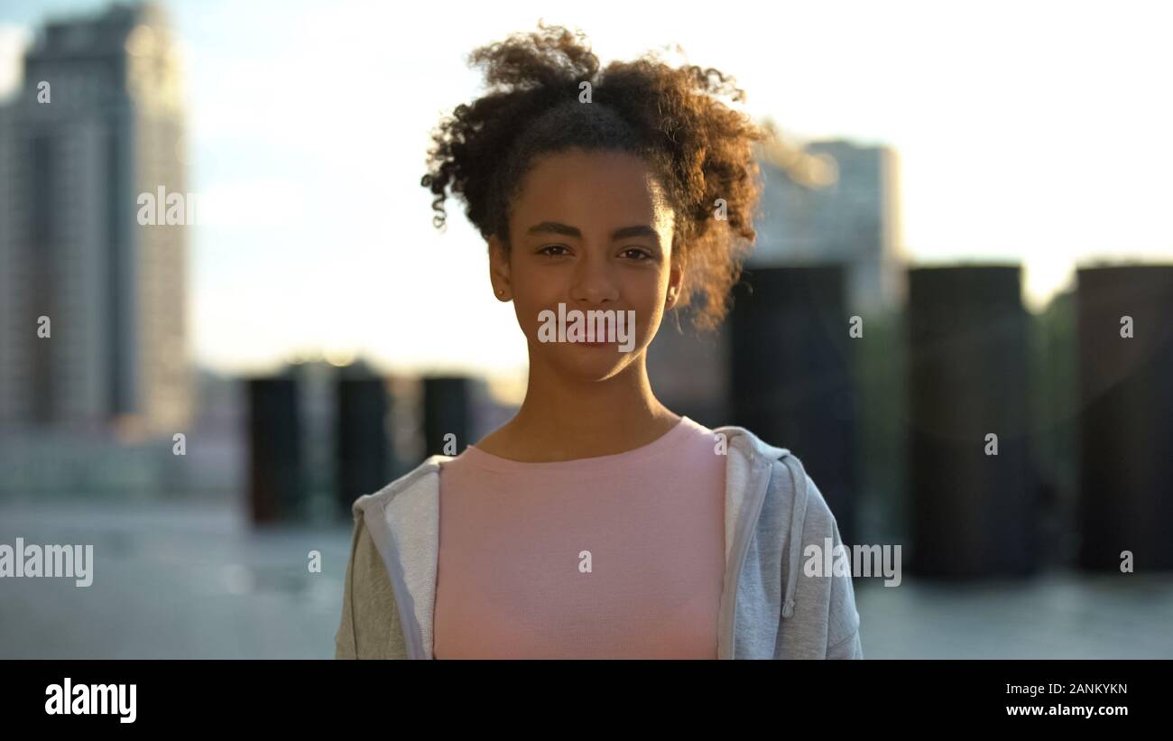 Cheerful mixed-race female teenager sincerely smiling on camera youth and future Stock Photo