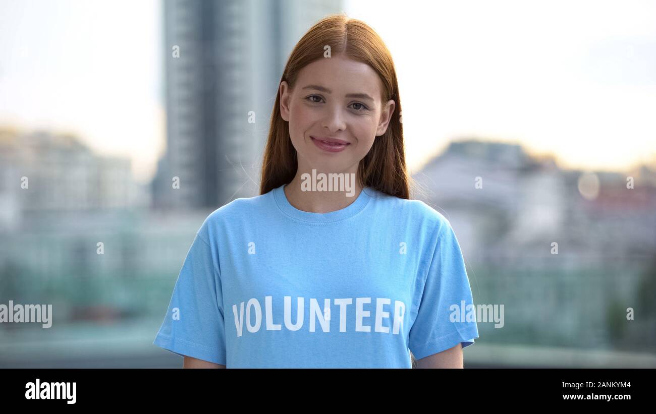 Red-haired female teenager smiling camera, college volunteer project, kindness Stock Photo