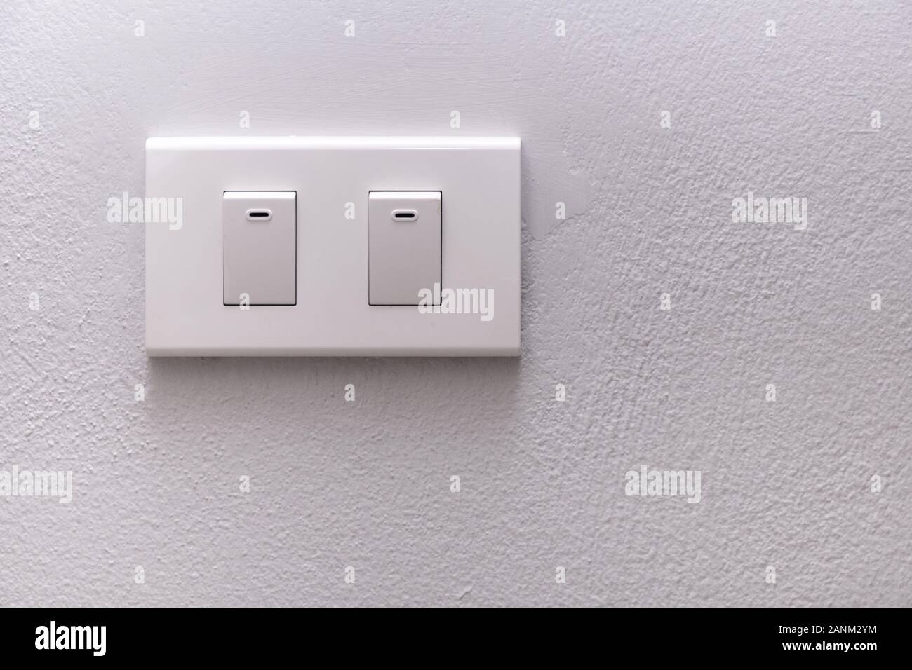 White electricity switch or lamp switch on white wall Stock Photo - Alamy