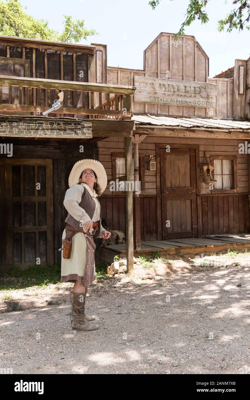 Pistol-Packin' Paula Saletnik shows off her Annie Oakley-style gun-twirling  and -tossing skills at the Old West town, audience-participation theme  park, working cattle ranch, and frequent movie, TV-commercial, and  country-music video set at