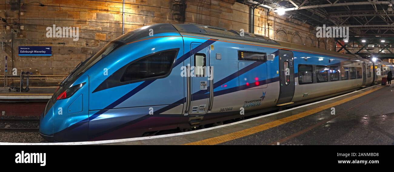 397003 British Rail Class 397 Civity EMU by CAF, in TPE,TransPennine Express livery, at night,Edinburgh Waverley Station, Scotland UK Stock Photo