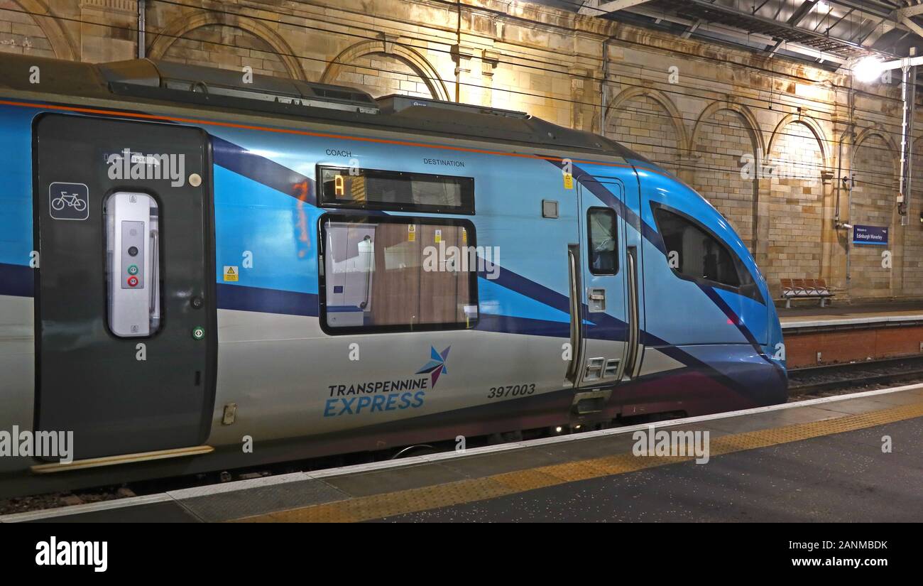 397003 British Rail Class 397 Civity EMU by CAF, in TPE,TransPennine Express livery, at night,Edinburgh Waverley Station, Scotland UK Stock Photo